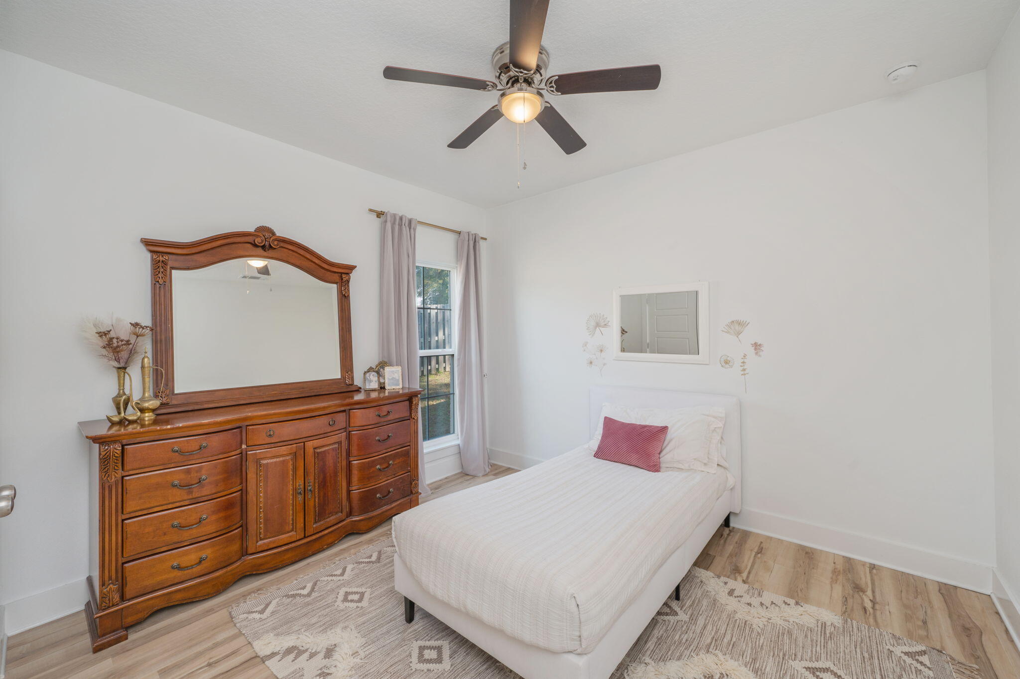 667 Red Fern Road Crestview, FL 32536 - Photo 29 of 42 a bedroom with a bed and a chandelier
