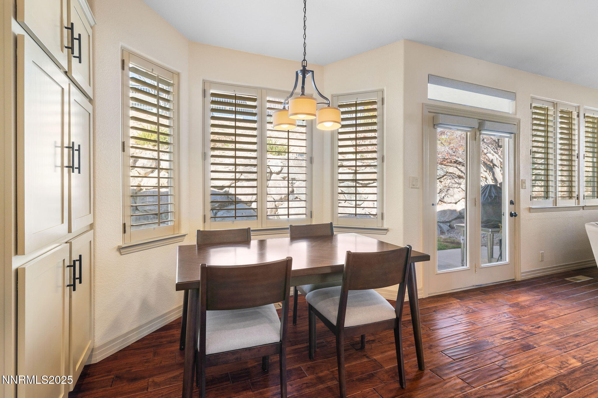 2255 Hogan Court Reno, NV 89523 - Photo 10 of 30 a dining room with wooden floor a chandelier a glass table and chairs