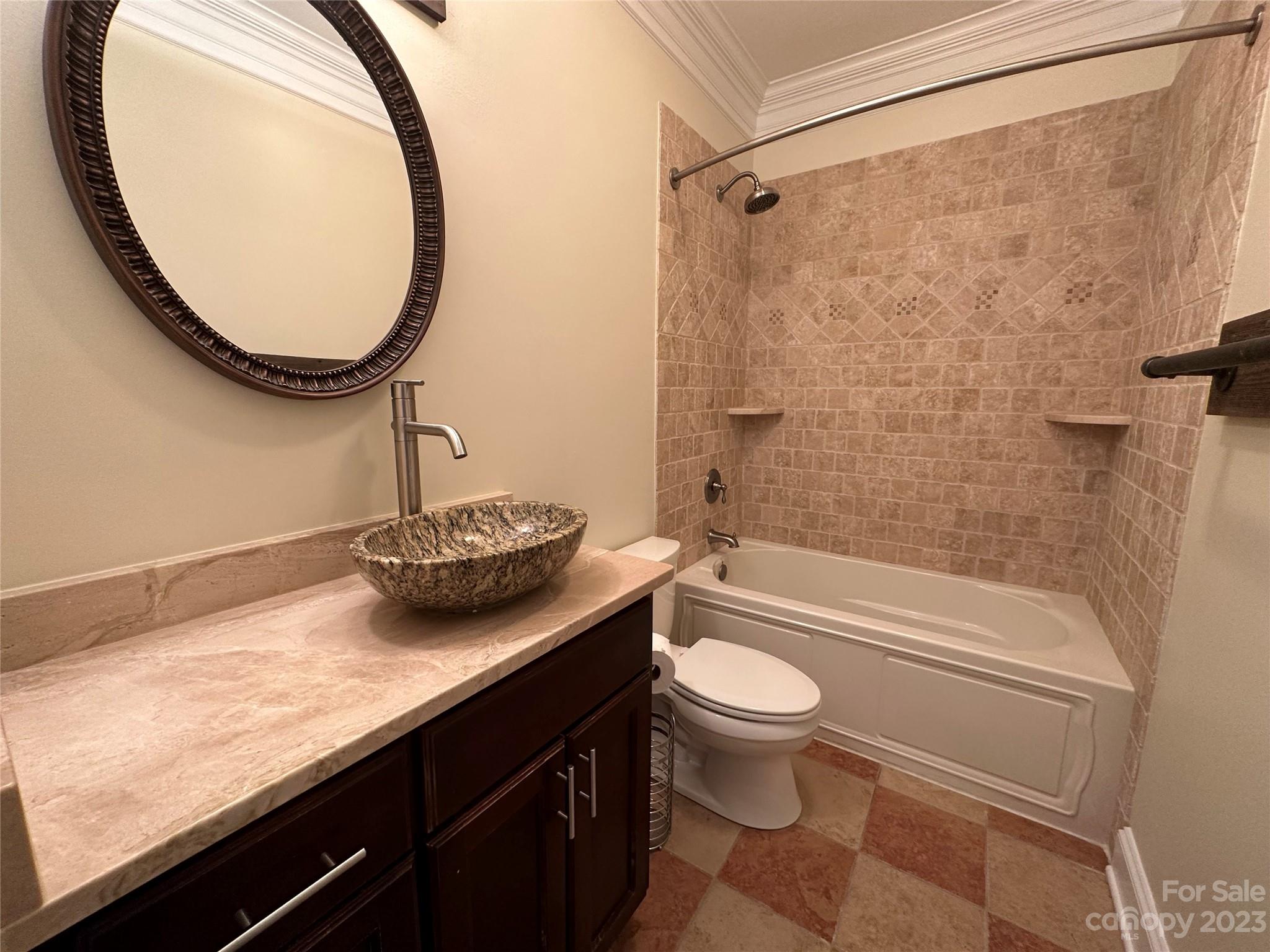 1334 Torrence Circle Davidson, NC 28036 - Photo 12 of 12 a bathroom with a granite countertop sink a toilet and bathtub