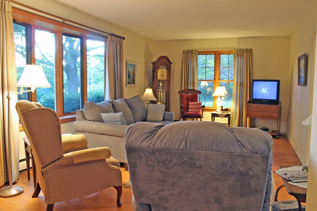 70 Buckland Road Ashfield, MA 01330 - Photo 18 of 30 a living room with furniture two large windows and a flat screen tv