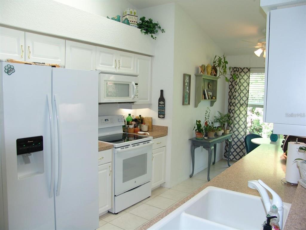 1605 Send Way Lutz, FL 33549 - Photo 3 of 24 a kitchen with stainless steel appliances white cabinets and a stove