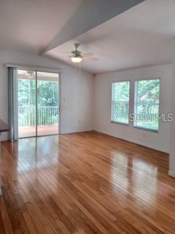 1605 Send Way Lutz, FL 33549 - Photo 7 of 24 an empty room with wooden floor and windows