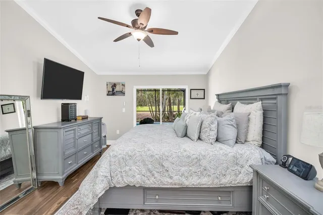 a bedroom with a large bed and a flat screen tv