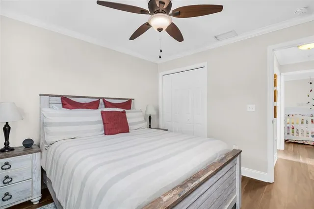 a bedroom with a bed and wooden floor