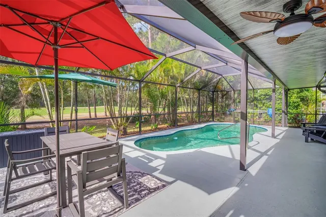 a backyard of a house with table and chairs