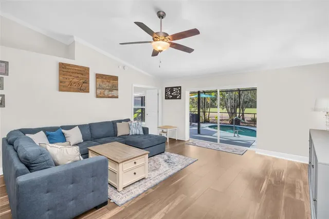 a living room with furniture and ceiling fan