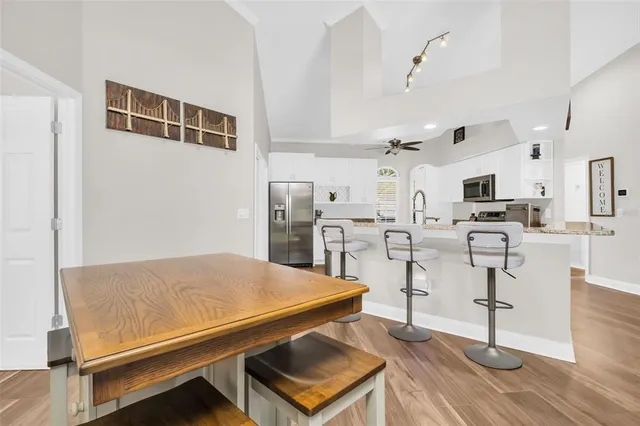 a living room with lots of furniture and kitchen view