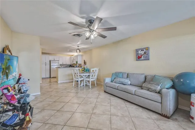 a living room with furniture and flowers