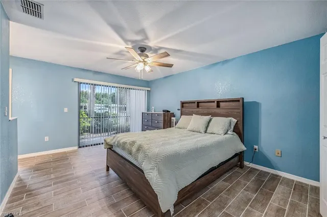 a large bedroom with a bed and a large window