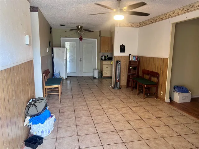 a view of a livingroom with furniture and a gym equipment