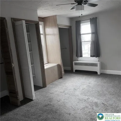 a view of an empty room with a window
