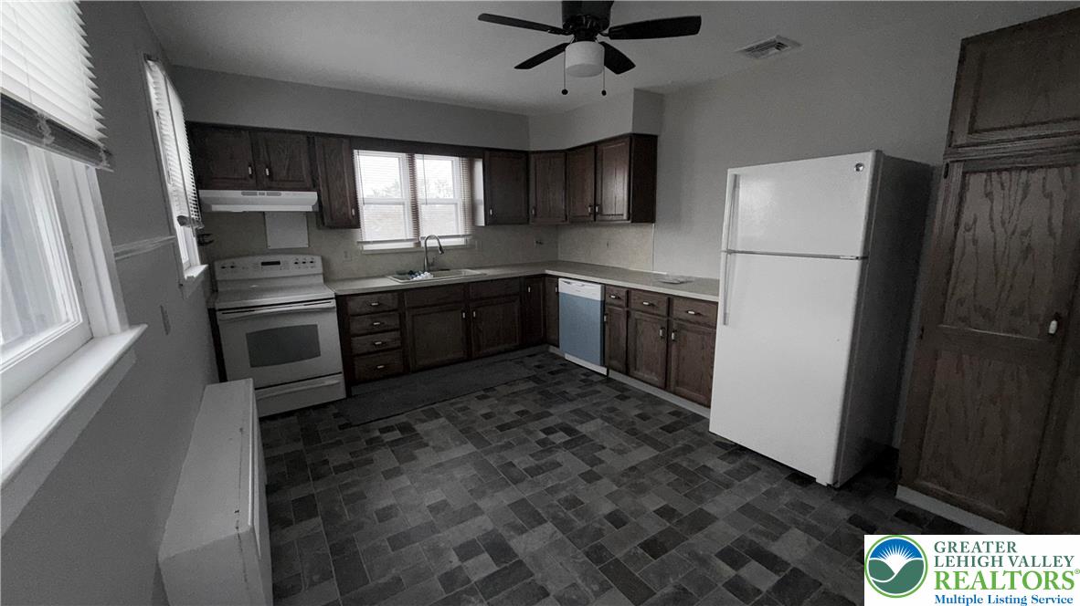 637 5th Street Whitehall, PA 18052 - Photo 6 of 16 a kitchen with stainless steel appliances granite countertop a refrigerator a stove a sink and a microwave