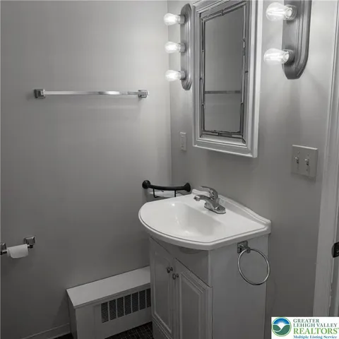 a bathroom with a sink and mirror