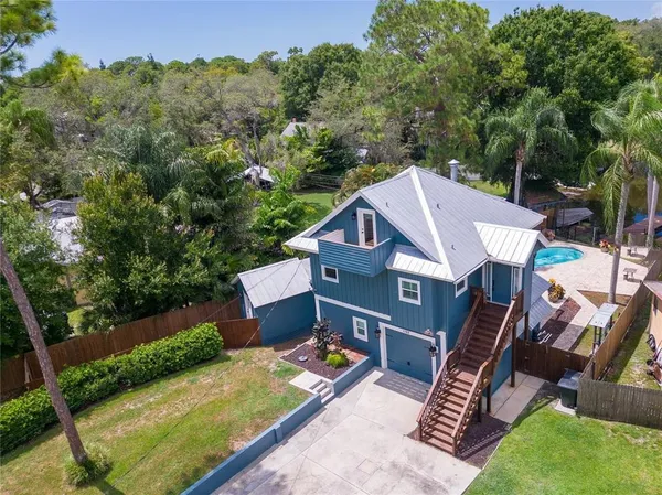 an aerial view of a house with swimming pool garden and patio