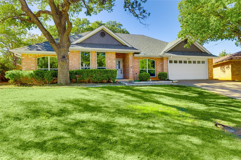 5210 Overridge Drive Arlington, TX 76017 - Photo 1 of 1 a front view of a house with a yard and garage