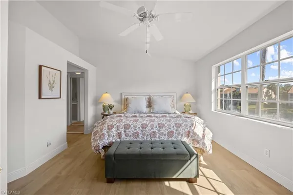 a bedroom with a bed lamp and a chandelier