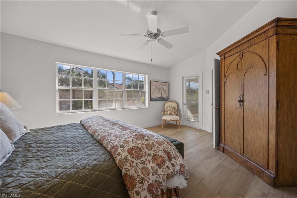 8415 Excalibur Circle, Unit B10 Naples, FL 34108 - Photo 16 of 26 a bedroom with a bed and a large window