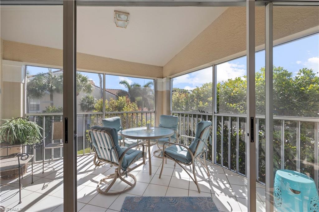 8415 Excalibur Circle, Unit B10 Naples, FL 34108 - Photo 20 of 26 a view of a city from a dining room with furniture