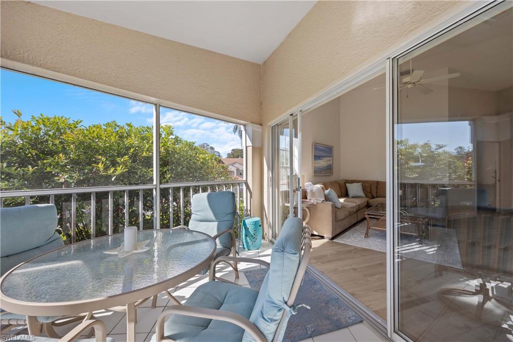 8415 Excalibur Circle, Unit B10 Naples, FL 34108 - Photo 22 of 26 a dining room with glass top table and chairs