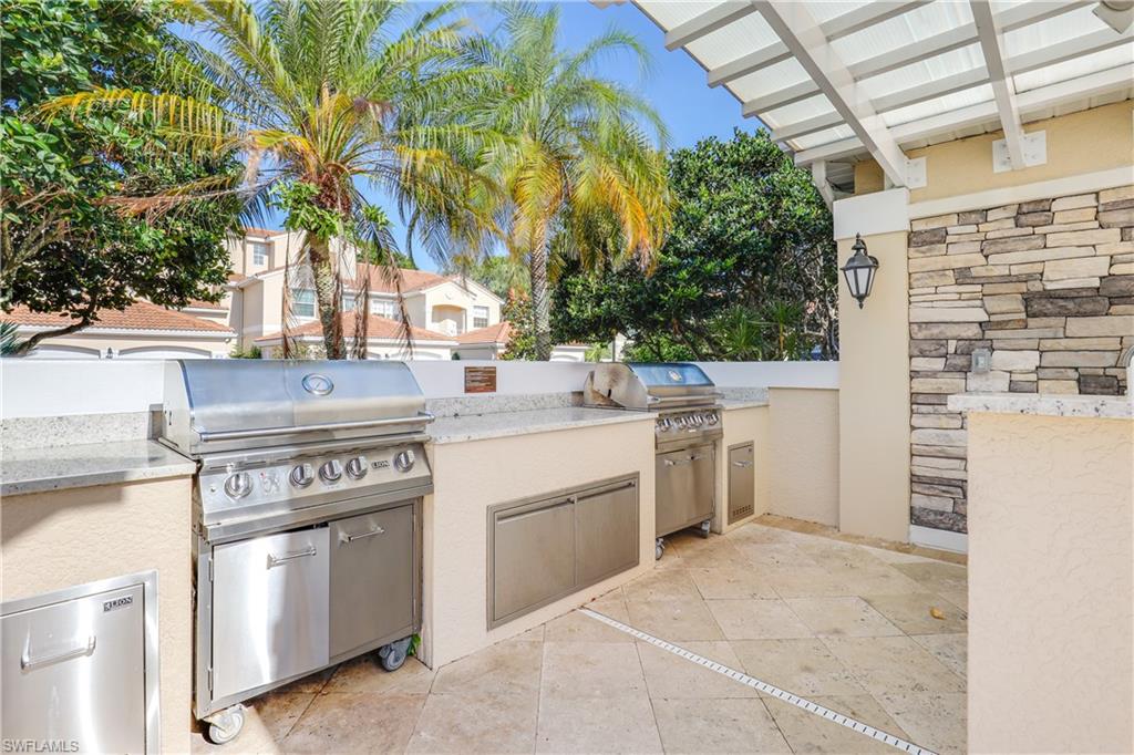 8415 Excalibur Circle, Unit B10 Naples, FL 34108 - Photo 25 of 26 a kitchen with a stove and a refrigerator