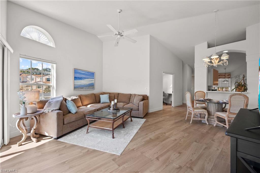 8415 Excalibur Circle, Unit B10 Naples, FL 34108 - Photo 7 of 26 a living room with furniture and a chandelier