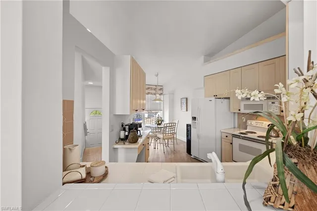 a view of a kitchen with white cabinets