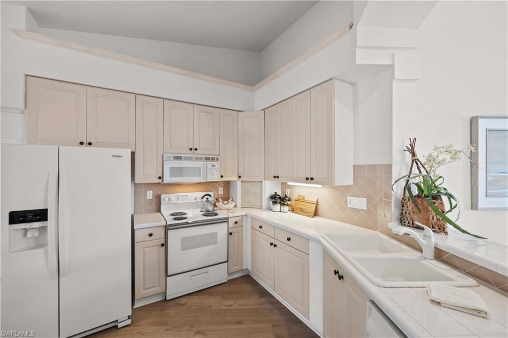 8415 Excalibur Circle, Unit B10 Naples, FL 34108 - Photo 10 of 26 a view of a kitchen with white cabinets