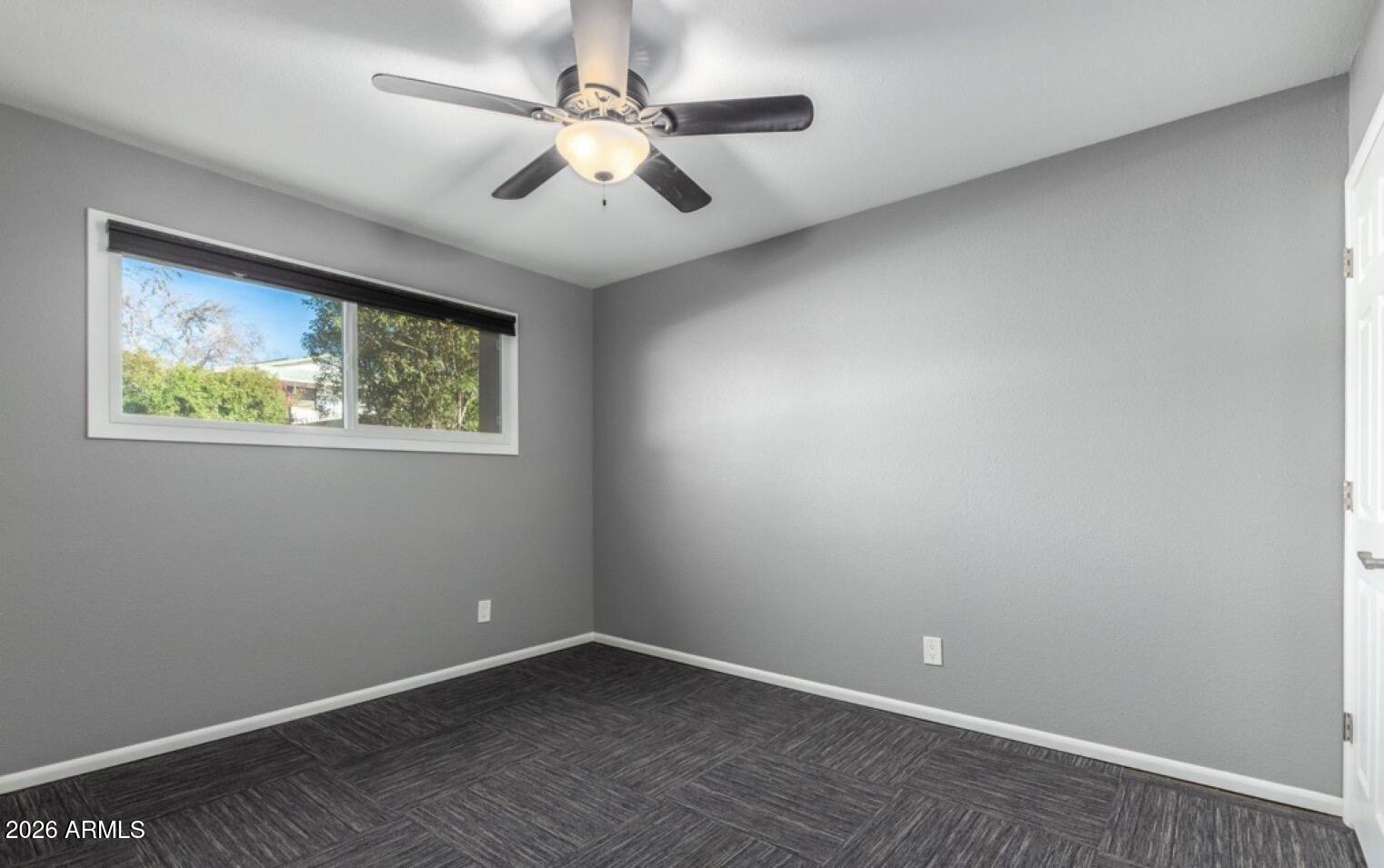5130 West Redfield Road Glendale, AZ 85306 - Photo 13 of 35 an empty room with windows and fan