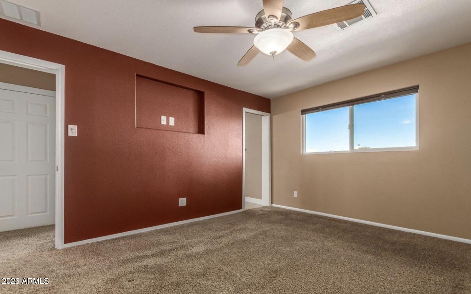 5130 West Redfield Road Glendale, AZ 85306 - Photo 20 of 35 an empty room with windows and fan