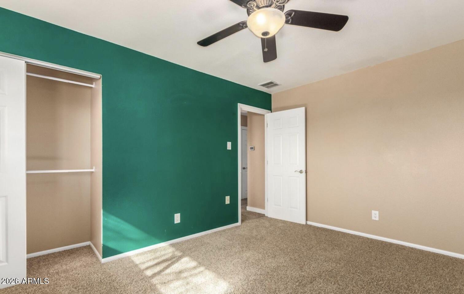 5130 West Redfield Road Glendale, AZ 85306 - Photo 27 of 35 an empty room with a fan & a window