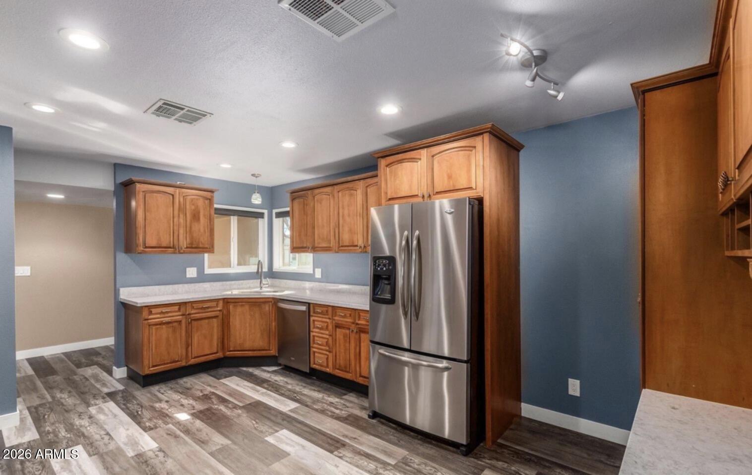 5130 West Redfield Road Glendale, AZ 85306 - Photo 5 of 35 a kitchen with stainless steel appliances granite countertop a refrigerator and a sink