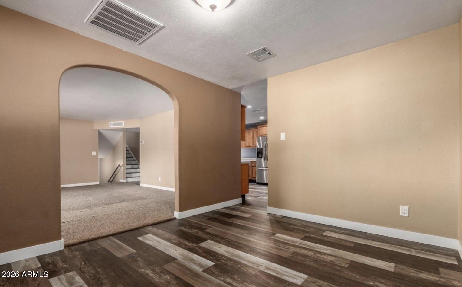 5130 West Redfield Road Glendale, AZ 85306 - Photo 10 of 35 a view of a hallway with wooden floor and a bathroom
