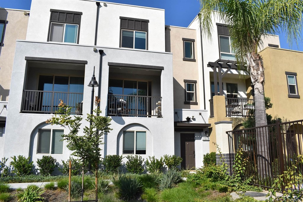 2229 Solara Lane Vista, CA 92081 - Photo 1 of 25 a front view of a multi story building with yard