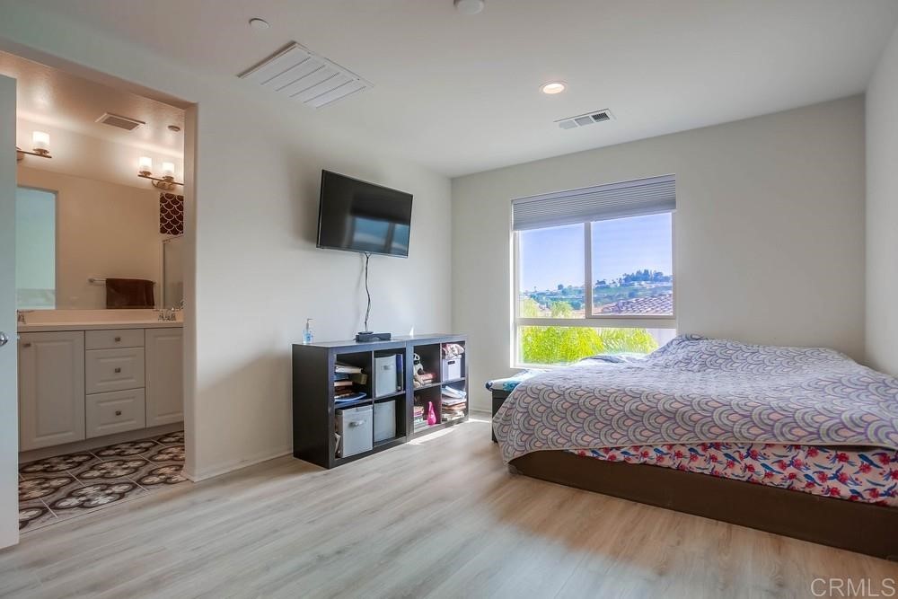 2229 Solara Lane Vista, CA 92081 - Photo 11 of 25 a living room with furniture and a flat screen tv