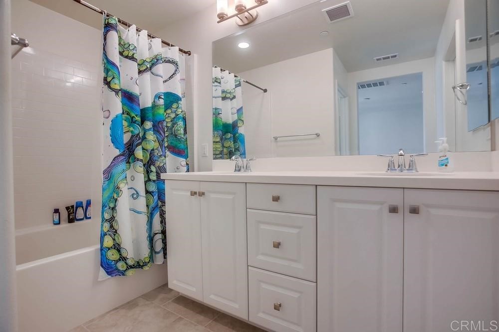 2229 Solara Lane Vista, CA 92081 - Photo 15 of 25 a bathroom with a sink a vanity and a mirror
