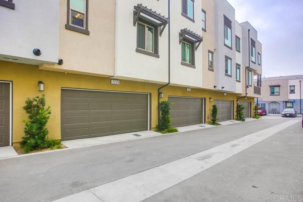 2229 Solara Lane Vista, CA 92081 - Photo 21 of 25 a front view of a building with a road