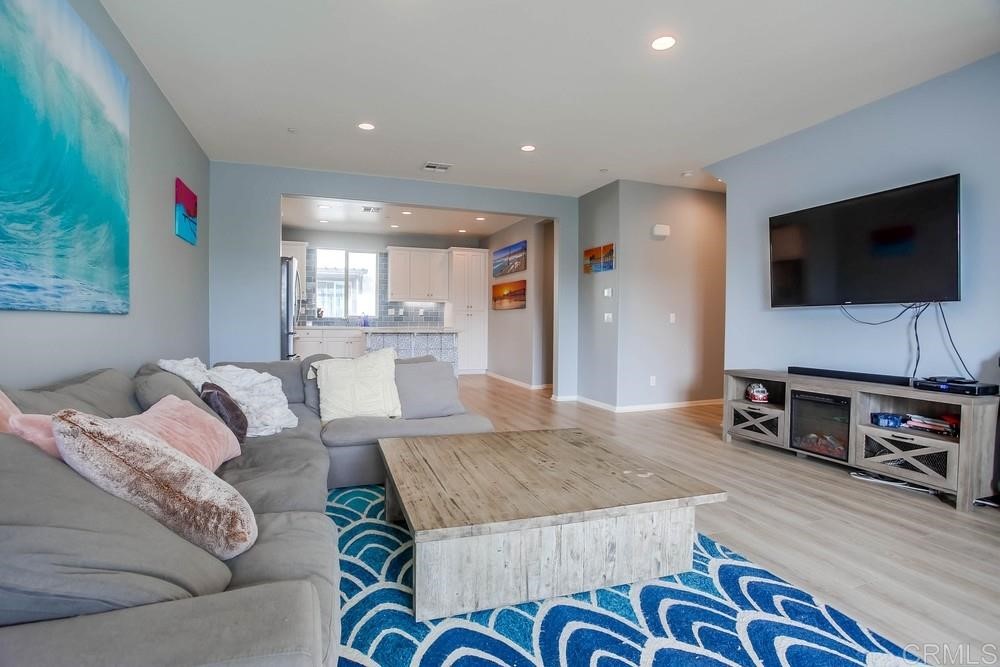 2229 Solara Lane Vista, CA 92081 - Photo 4 of 25 a living room with furniture and a flat screen tv