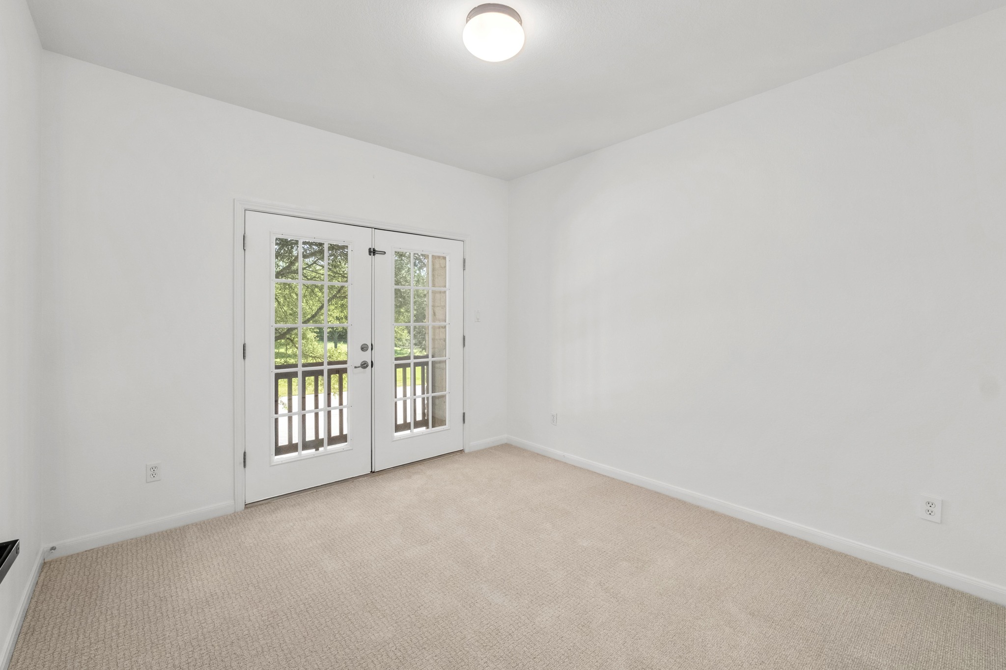 16200 Spillman Ranch Loop Austin, TX 78738 - Photo 27 of 36 French doors open to an outdoor view, creating a serene and naturally lit interior.