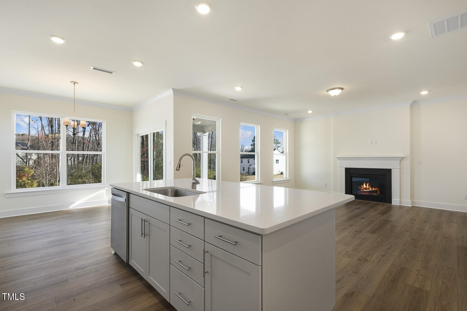 82 Gander Drive Benson, NC 27504 - Photo 33 of 33 a large hall with kitchen island a sink wooden floor and a fireplace