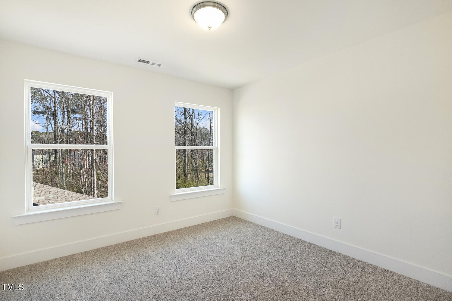 82 Gander Drive Benson, NC 27504 - Photo 18 of 33 an empty room with windows