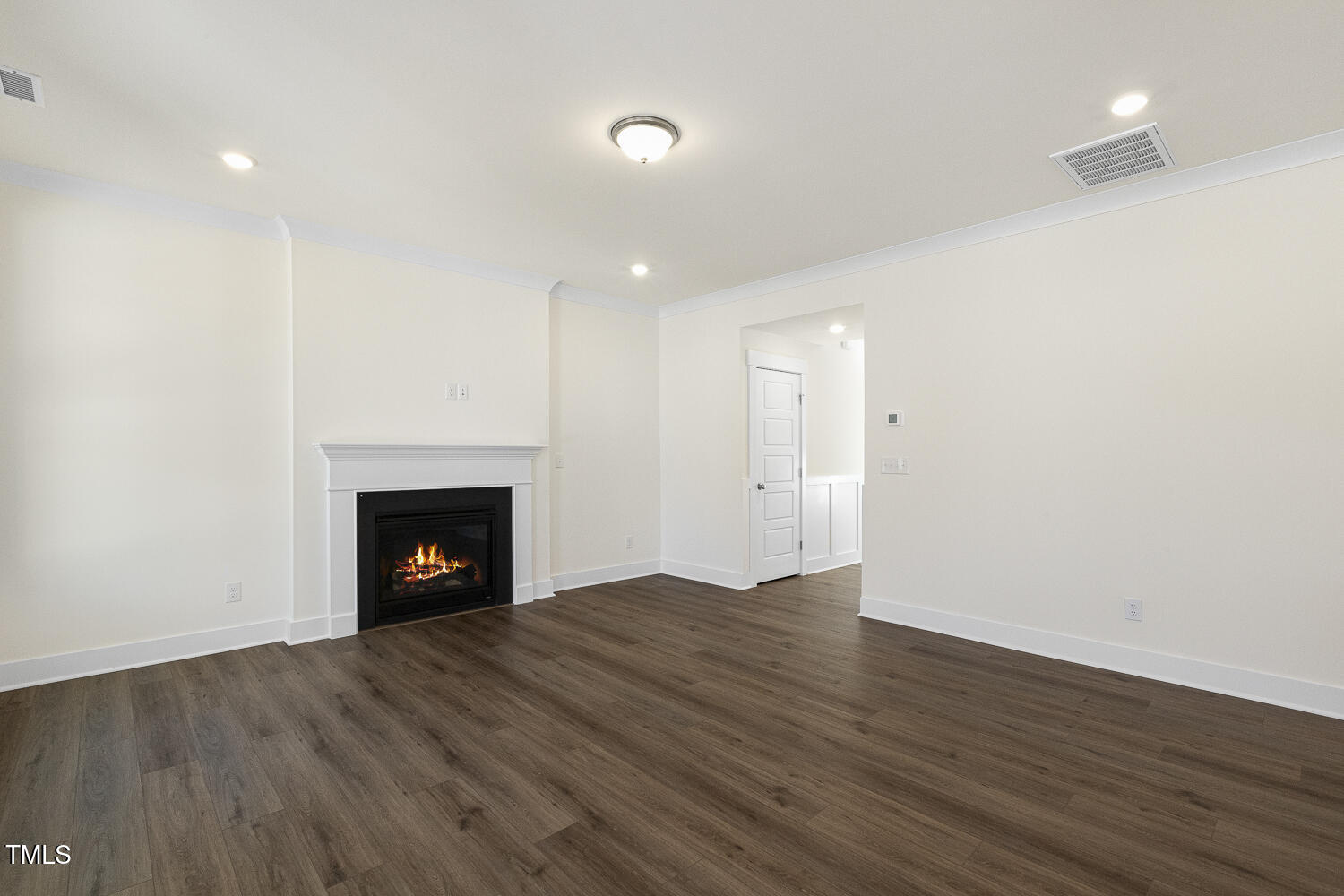 82 Gander Drive Benson, NC 27504 - Photo 8 of 33 a view of an empty room with wooden floor fireplace and a window
