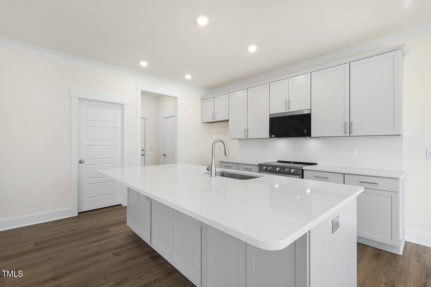 82 Gander Drive Benson, NC 27504 - Photo 10 of 33 a kitchen with stainless steel appliances a sink a stove a microwave and cabinets