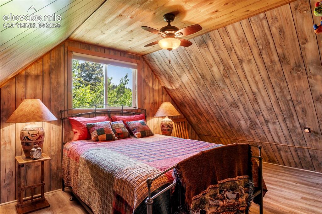 546 Pulver Road Lake George, CO 80827 - Photo 20 of 45 a bedroom with a bed and a chandelier