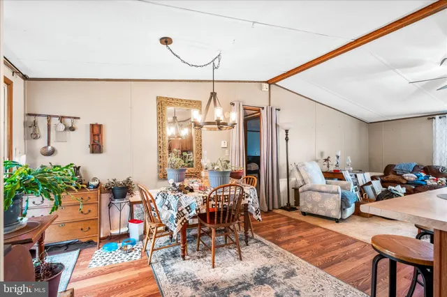 a very nice looking living room with a dining table furniture and a chandelier