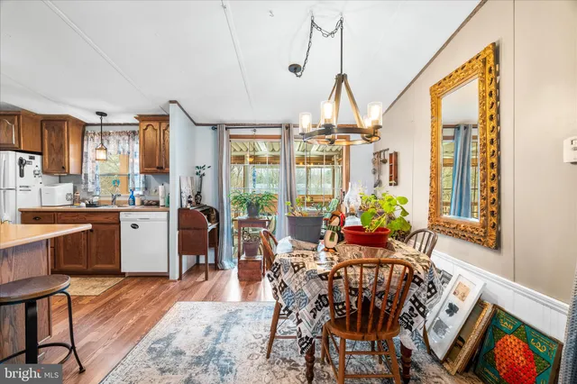 a very nice looking living room with a large window and dining table