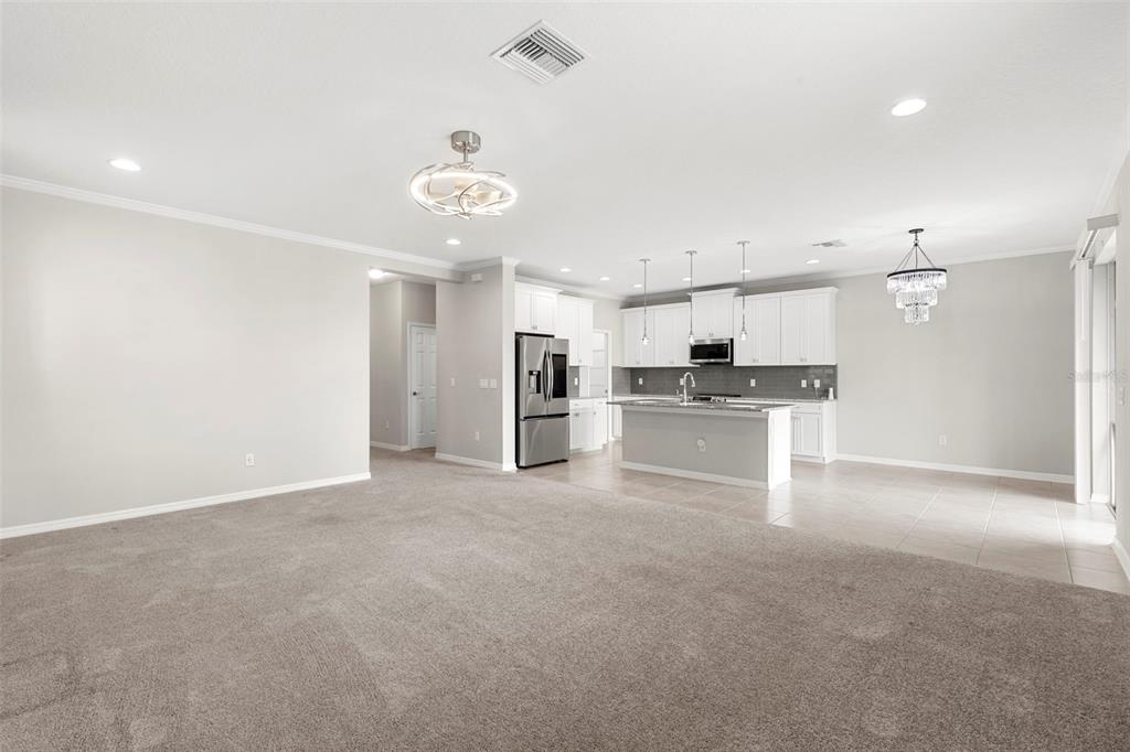 7537 Pool Compass Loop Wesley Chapel, FL 33545 - Photo 12 of 50 a view of a kitchen with a sink and white cabinets