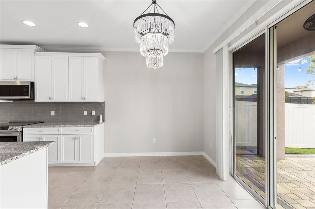 7537 Pool Compass Loop Wesley Chapel, FL 33545 - Photo 13 of 50 a kitchen with stainless steel appliances granite countertop a refrigerator a stove and a sink