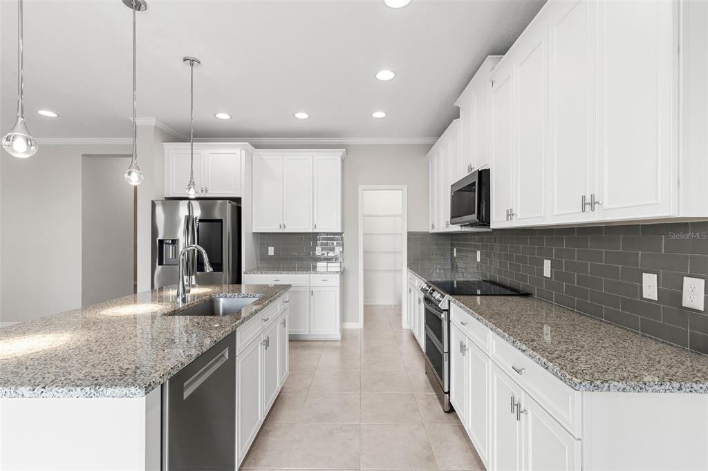 7537 Pool Compass Loop Wesley Chapel, FL 33545 - Photo 15 of 50 a kitchen with a sink stove and refrigerator