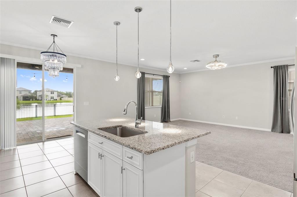 7537 Pool Compass Loop Wesley Chapel, FL 33545 - Photo 19 of 50 a kitchen with granite countertop a sink a counter top space and cabinets