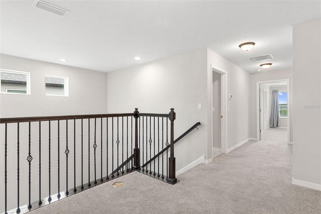 7537 Pool Compass Loop Wesley Chapel, FL 33545 - Photo 22 of 50 a view of a hallway